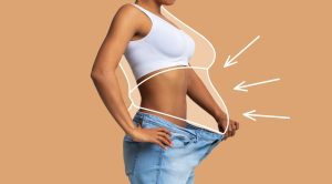 image showing a women that lost weight and her loose jeans