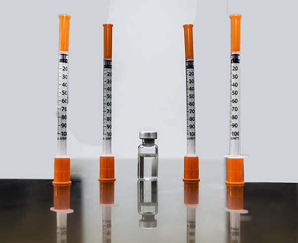 Vial of compounded tirzepatide, the active ingredient of Zepbound or Mounjaro, and four insulin syringes